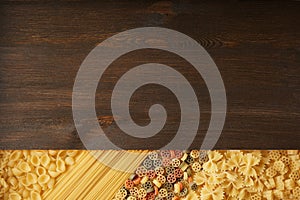 Several types of dry pasta with dark wood