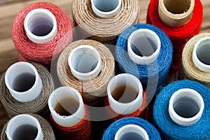 Several varicolored spools of thread