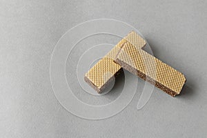 Several wafers with chocolate on a light background. Selective focus