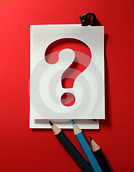 Paper notes with question marks on red background, flat lay. Space for text