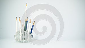 Several white pencils pasted