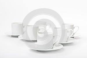 Several white porcelain cup and saucer for coffee isolated on white background