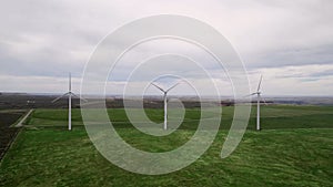 Several wind generators on a farm spinning in the wind