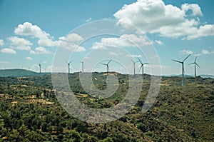 Several wind turbines over hilly landscape