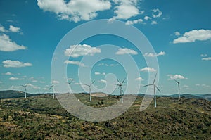 Several wind turbines over hilly landscape