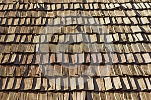 Several wood cedar shingles for siding or roofs. Brown wood roof shingles