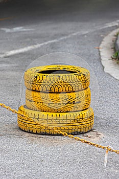 several yellow tire chains on the pavement near an orange fire hydrant