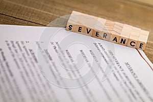 Severance Pay concept with agreement document on wooden board