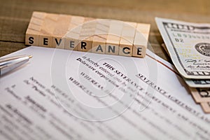 Severance Pay concept with agreement document on wooden board