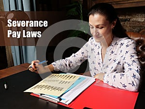 Severance Pay Laws sign. Closeup portrait of unrecognizable successful Businesswoman wearing formal suit reading documents