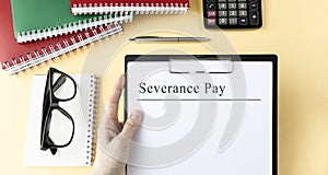 SEVERANCE PAY loan on a table. Office workplace