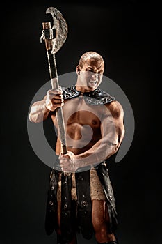 Severe barbarian in leather costume with hammer