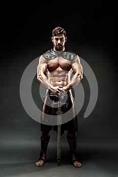 Severe barbarian in leather costume with sword