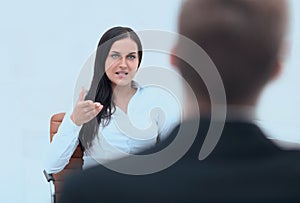 Severe female manager criticize her team member photo