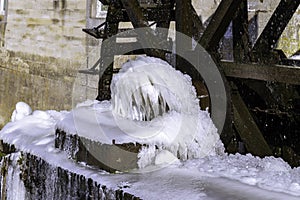 During severe frosts in winter, the water around the watermill`s radars freezes into beautiful natural structures. photo