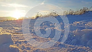 Severe Russian winter snowy landscape, sunset