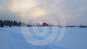 Severe Russian winter snowy landscape, sunset