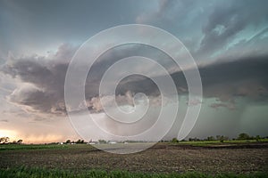 A severe storm rains heavily on the flat farmland of the great plains.