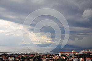 Severe weather storm with black clouds coming all over city and Adriatic Sea photo