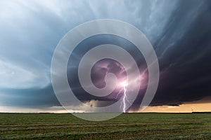 Severe weather. Thunderstorm lightning strike with dark clouds