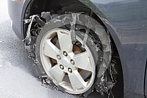 Severely Blown-out Tire with rubber ripped to shreds.