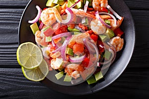 Seviche from marinated shrimp with avocado, pepper, tomatoes and photo