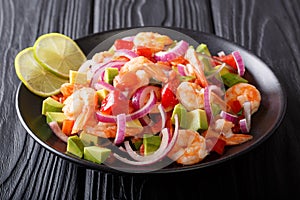 Seviche from marinated shrimp with avocado, pepper, tomatoes and photo