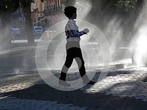 Child in fountain spray