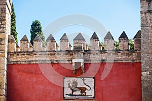 Coat of arms of the Spanish king Pedro I over the Lion's Gate to Alcazar Gardens