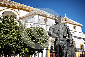 Seville, Andalusia, Spain: The statue of Curro Romero, a famous torero from Seville, in front of Plaza de Toros de la Maestranza photo