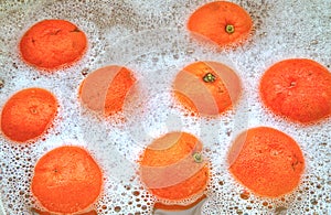 Seville oranges, soaking in soapy water