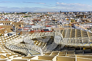 Seville skyline with wooden roof with walkways called Setas de Sevilla in the foreground, Spain