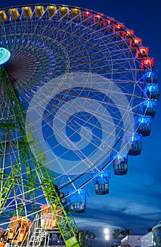 Seville, Spain - April 23, 2015: Ferris wheel illuminated at night in april fair of Seville