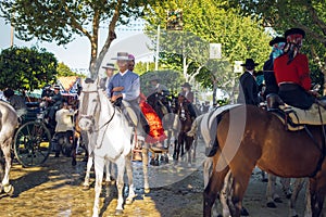 Group of riders on horseback enjoy April Fair, Seville Fair Feria de Sevilla.