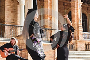 Seville, Spain - Jan 31 2022: A group of flamenco dancers and Spanish guitar player performing in the street