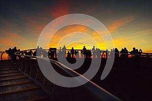 SEVILLE,SPAIN-March 8:Group of people looking at sunset and citycsape in Seville.Andalucia,Spain.Tourists sightseeing,enjoying