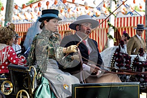 Elegant woman driving horse carriage at the April Fair Feria de Abril, Seville Fair