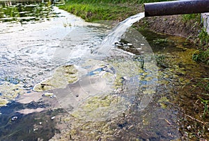 Sewage drains into the river. Environmental pollution photo