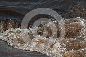 Sewage pipe outfall into the river, water pollution and environmental damage concept