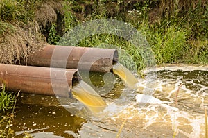 sewage from the sewer pollutes a lake/water gushing from the sewer to the river