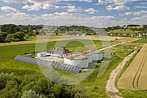 A sewage treatment plant away from the city among the fields. Solar cells are accumulating free energy. Ecology of the use of natu