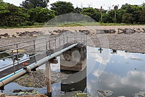Sewage water treatment pond with selective focus - bridge to sediment pond