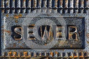 Sewer access cover with rusty iron