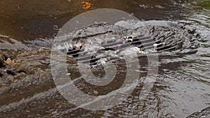 Sewer clogged with trash at  heavy rain. Flooded street.