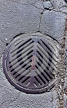 Sewer grate in asphalt