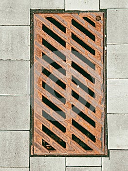 Sewer grate on paving slabs