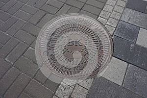 Sewer manhole on the pavement in the city of Kiev.