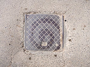 Sewer metal hatch on pavement