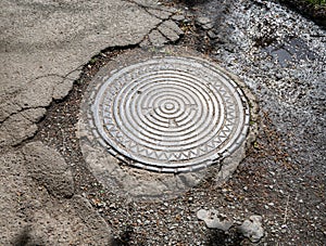 Sewer metal hatch on pavement