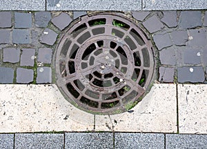 Sewer metal hatch on pavement